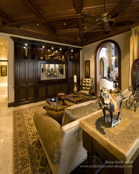 Wood-beamed ceilings ensconce the family room and kitchen.