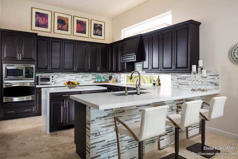 Custom pulls replace the original knobs on the doors of existing millwork. New pure white quartz slabs were added throughout the area. We lowered the countertop to a constant 36