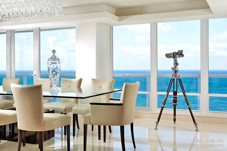 A large Macassar Ebony and stainless dining table was custom made to accommodate large parties. The glass table top appears to float under the Marino LED chandelier.