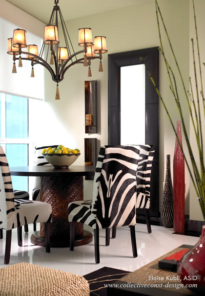 ...bold zebra printed hide on the dining chairs by Palecek create a striking balance against the white thassos marble with black Absolute border.