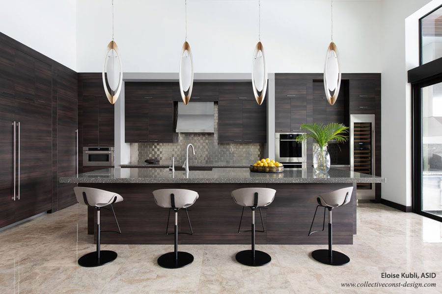 Modern interior designed custom kitchen with professional appliances and pendant lighting.