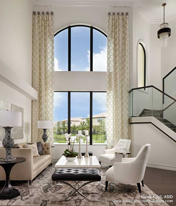 The tall draperies add soft, elegant columns to the glamorous Living Room.