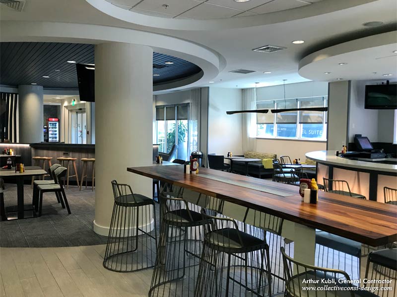 A new custom reclaimed acacia wood and stainless steel base communal table was added to the dining area.