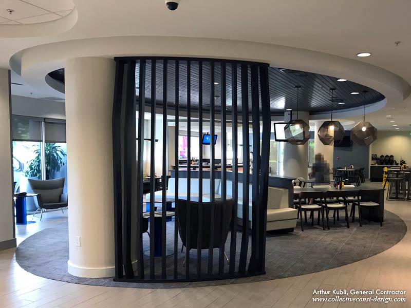A room divider is between the front desk and dining area. The existing wood ceiling was newly stained.