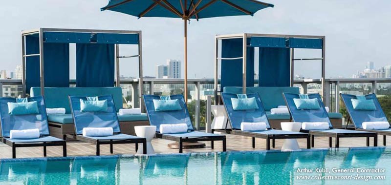 Rooftop pool and deck renovation features poolside cabanas and luxe chaise lounges.