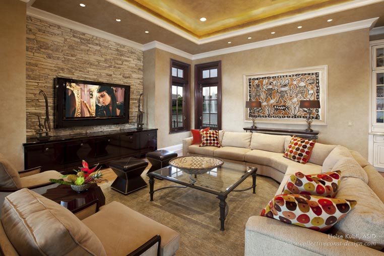 The television is the focal point in the family room. To add more interest, linear stacked stone was installed above the custom built-in. Durable fabrics were used on all the upholstered pieces.