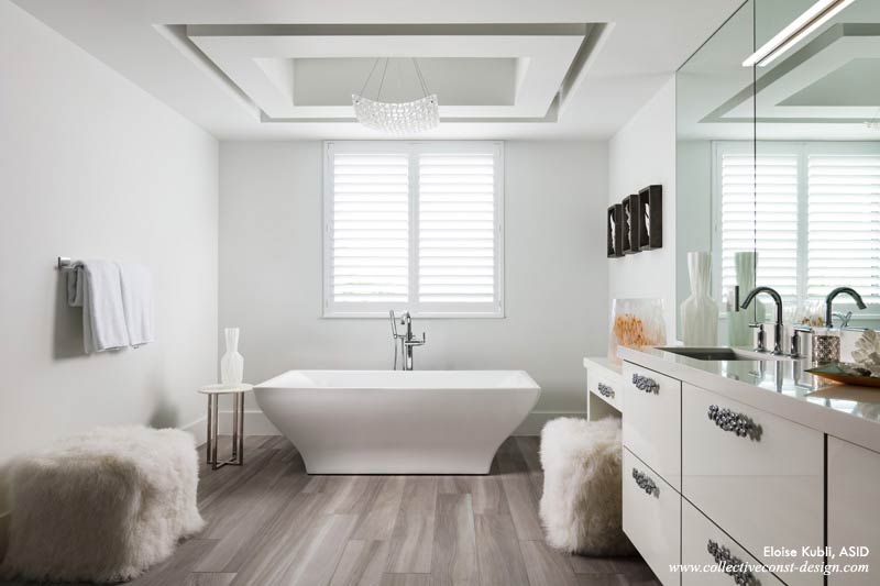 A pendant light made from pillow-shaped pieces of fused glass is suspended on rods covered in silver leaf in the master bath. (Courtesy of Collective Construction &  Design)