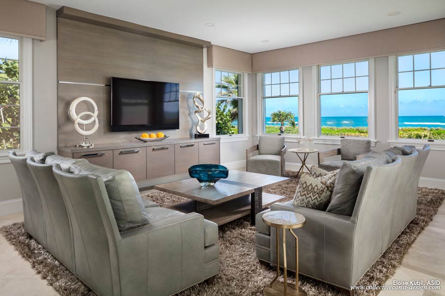 The custom wall unit in a metallic grey finish is placed adjacent to the vast ocean views beyond. 