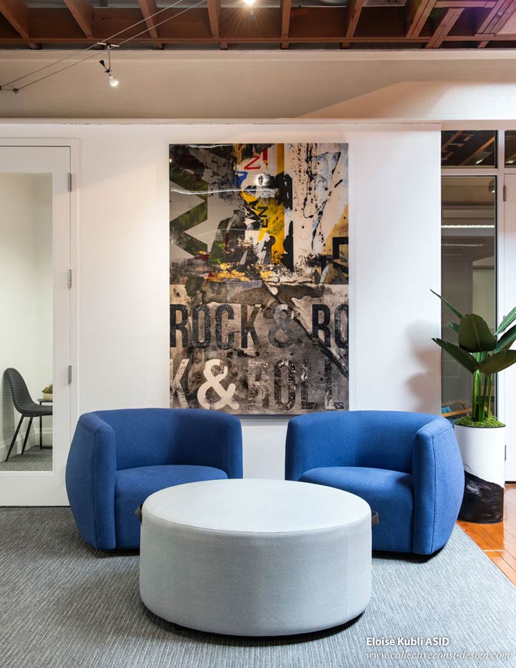Colorful graphics and blueberry chairs in this collaboration area. Vibrant colors and shapes in furnishings and artwork energize creativity and brighten the entire space.