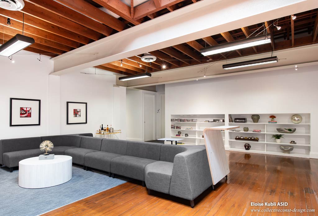 On entering the offices, the large open space features a comfortable two-sided lounge seating area with a standing height worktable.