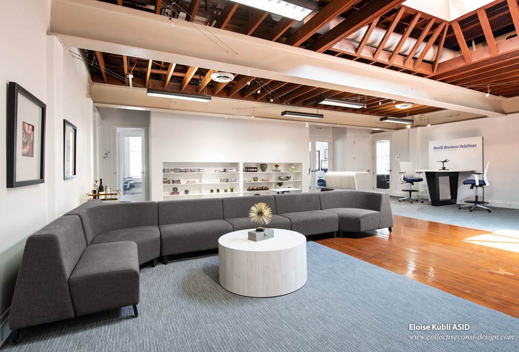 On entering the offices, the large open space features a comfortable two-sided lounge seating area with a standing height worktable.