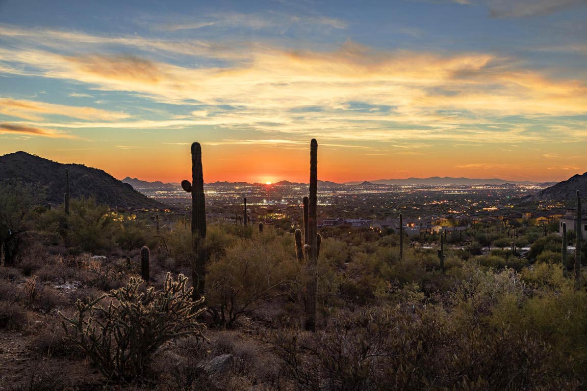 View from estate terrace of city and mountains in the distance.