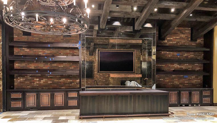 Wine room bar area, brass footrail, flanked by custom millwork. Exposed rough-hewn ceiling beams.